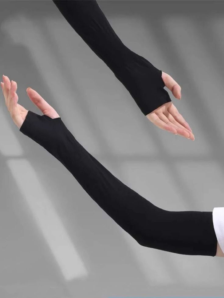 Black arm sleeves worn by a person on a gray background